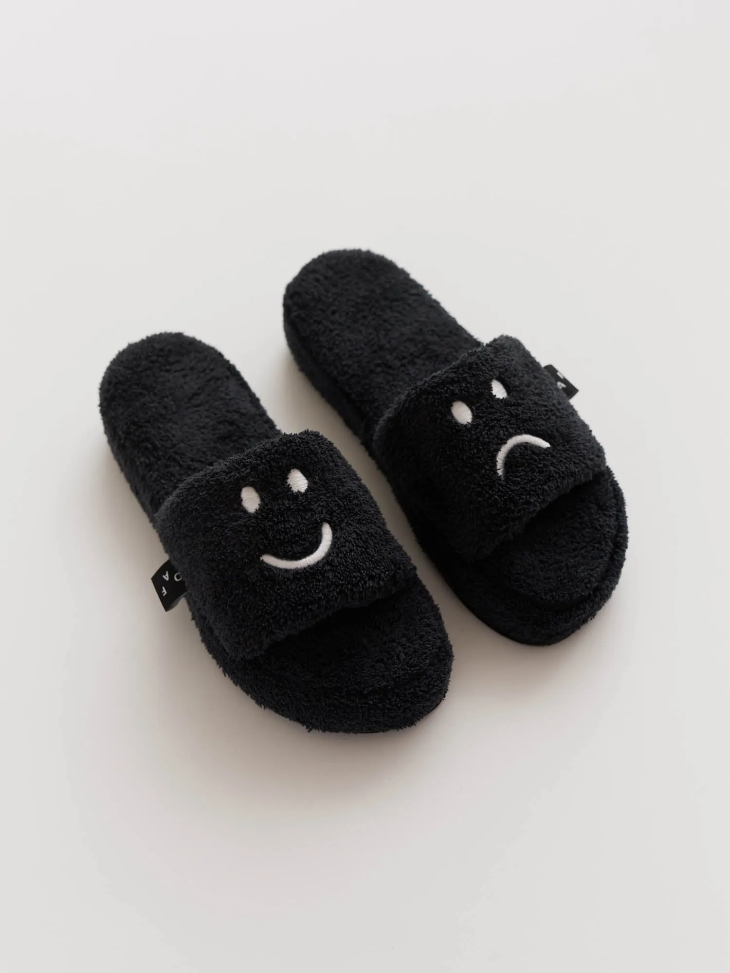 Happy Sad Slippers sold by Lazy Oaf