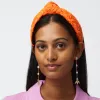 FIRE KNOTTED FLOWER PATCH HEADBAND sold by Lele Sadoughi