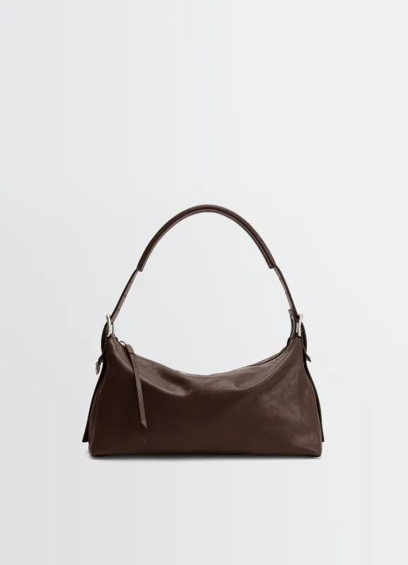 BELTED BAGUETTE BAG IN LEATHER made by Lemaire