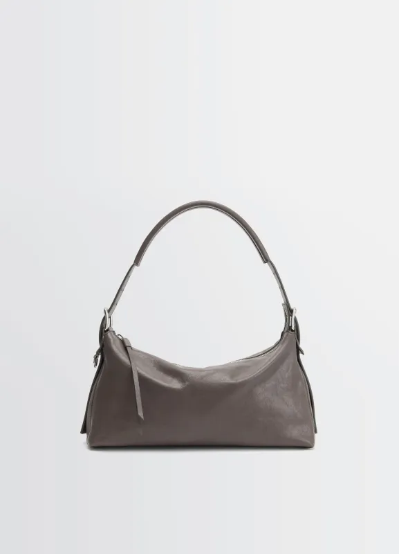 BELTED BAGUETTE BAG IN LEATHER made by Lemaire