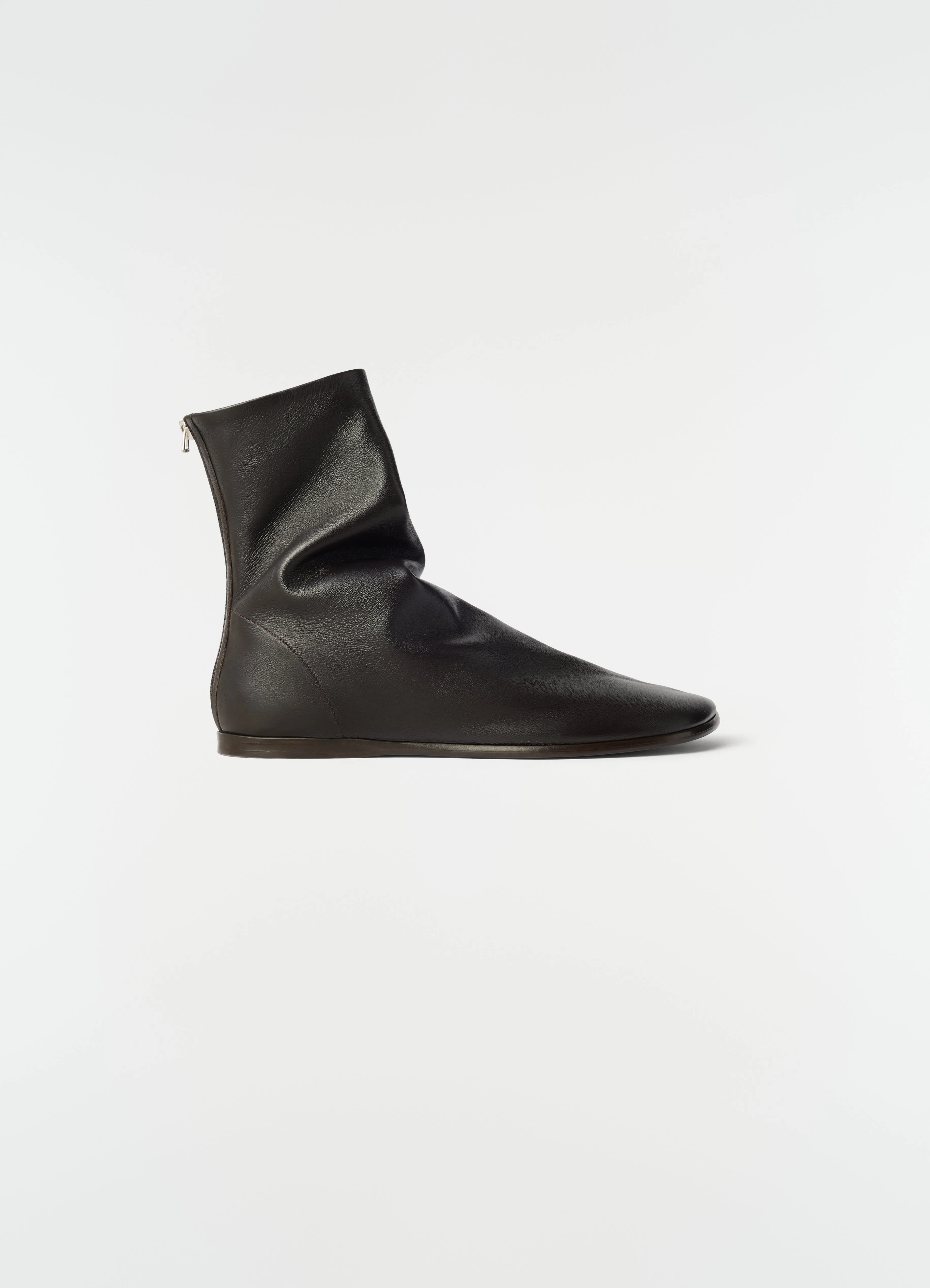 FLAT GLOVE ANKLE BOOTS IN SHINY NAPPA LAMBSKIN sold by Lemaire