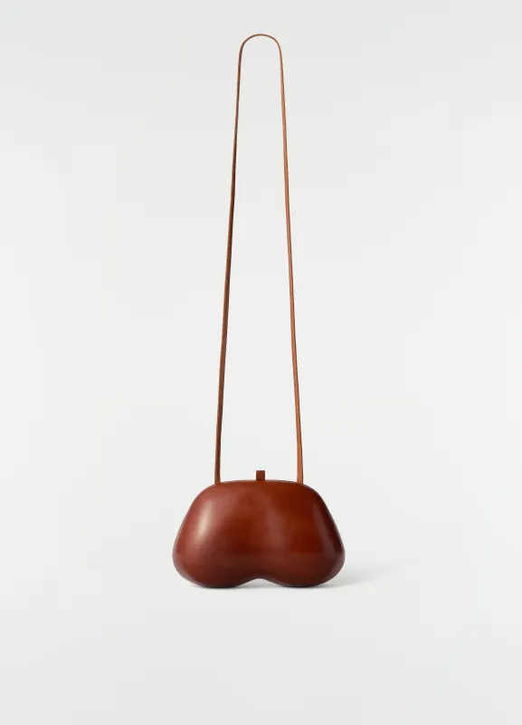FESSES CLUTCH IN PATINATED CALFSKIN made by Lemaire