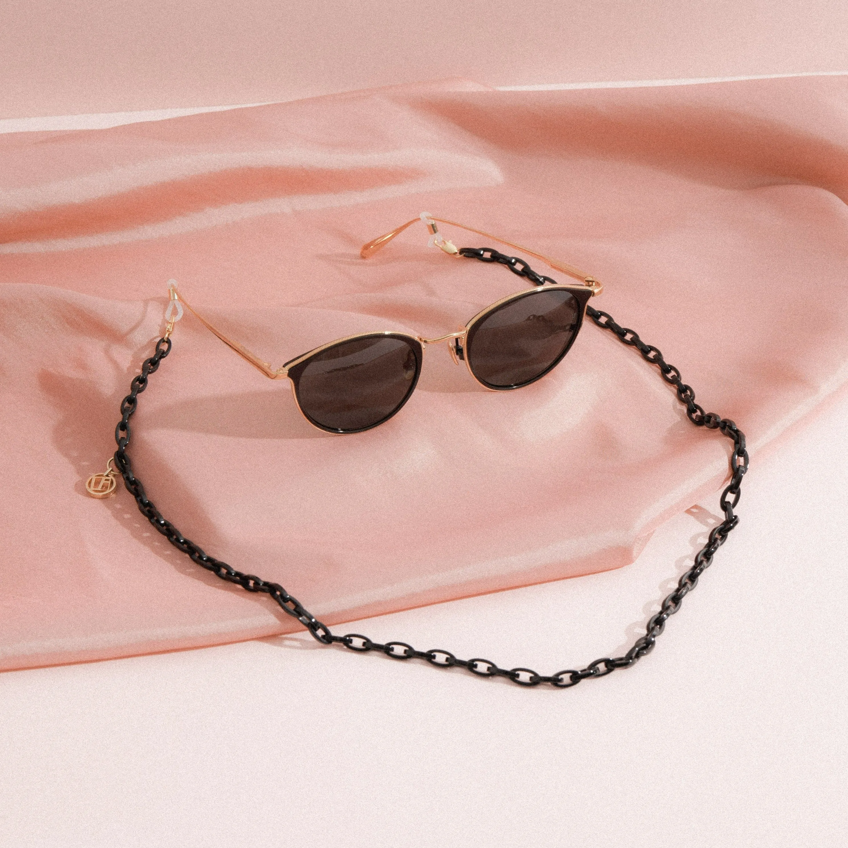 Luis Oval Sunglasses in Yellow Gold and Black sold by Linda Farrow
