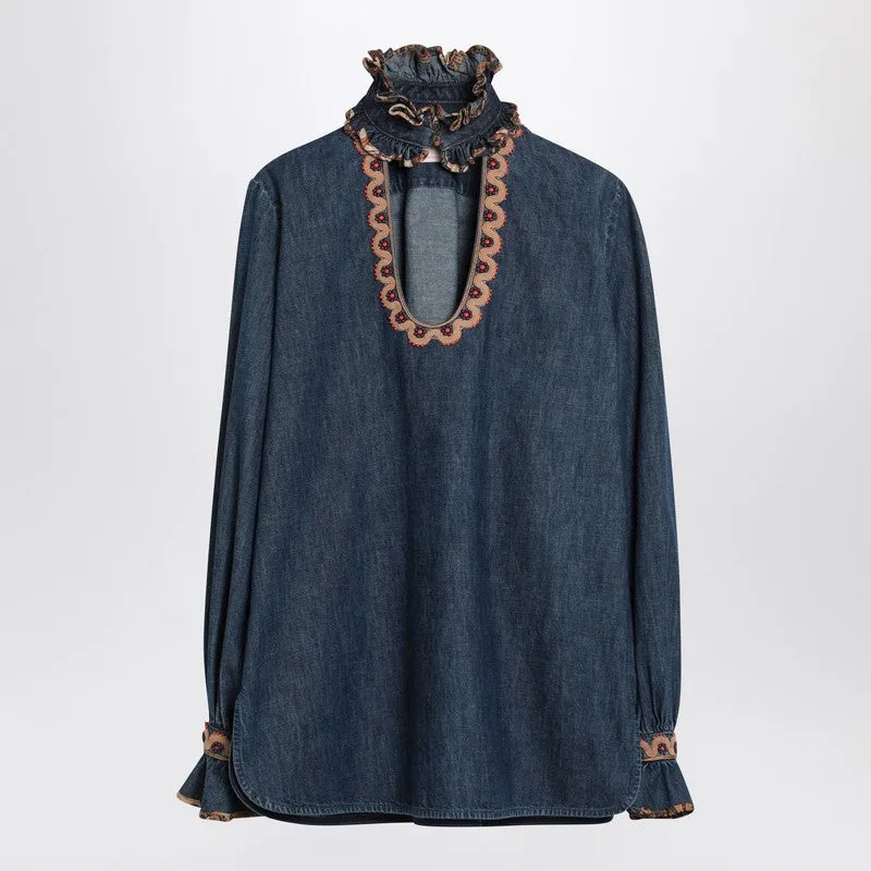 Blue denim blouse with embroidered edges sold by Lord & Taylor