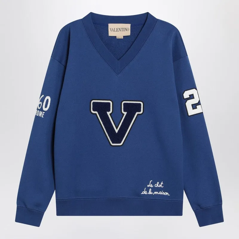 Blue sweatshirt with V and Le Chat de la Maison embroidery sold by Lord & Taylor