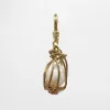 Handmade Nested and Caged Baroque Pearl in Brass & Goldfill Perla Charm sold by Lulu Frost