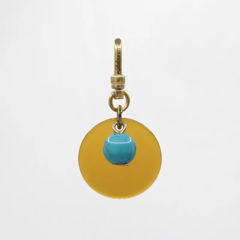 Sun & Moon Saffron Translucent Bakelite with Turquoise Glass Bead Dua Charm sold by Lulu Frost