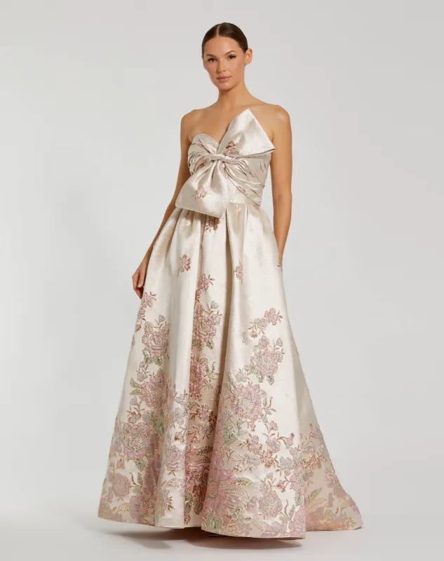 Ivory Strapless Brocade Floral Ball Gown With Bow Detail sold by Mac Duggal
