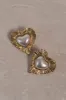 Heart To Heart Pearl Earrings - Gold sold by Meshki
