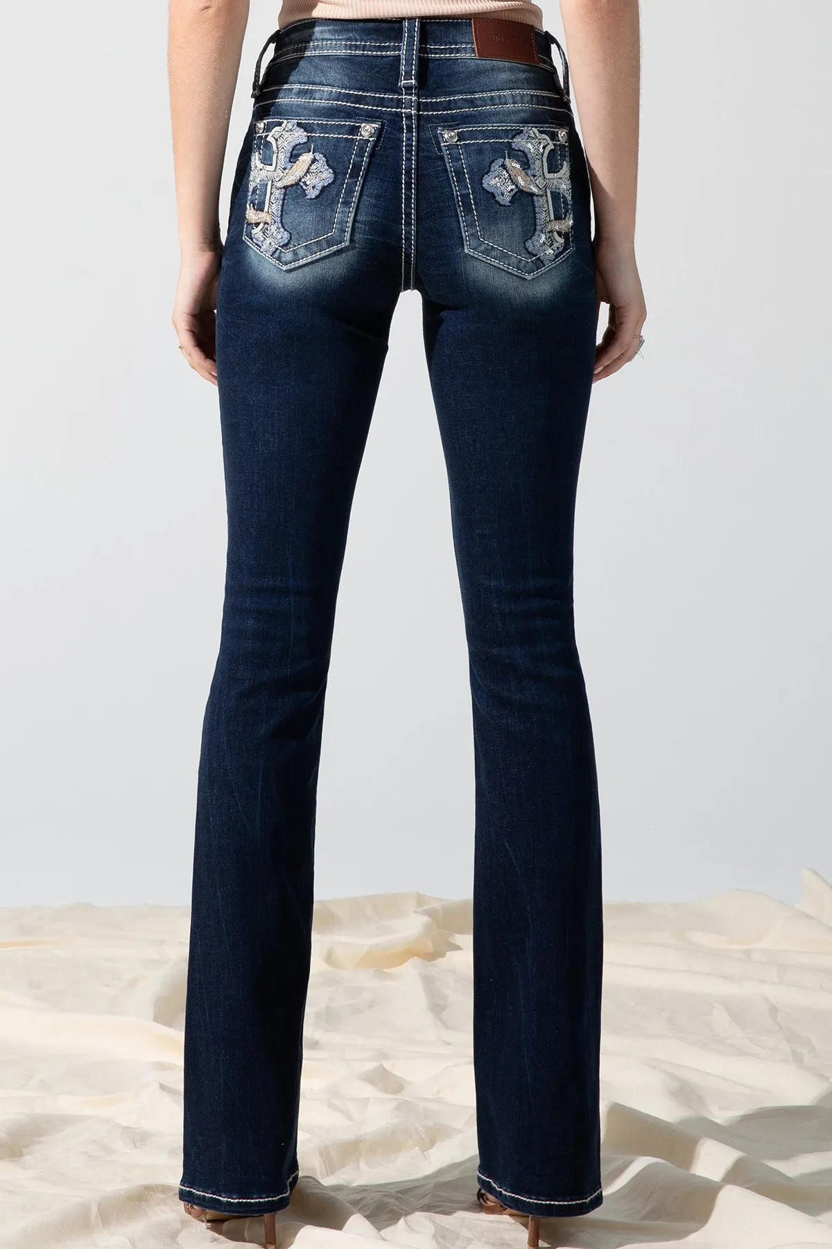 Feathered Cross Bootcut Jeans sold by Miss Me
