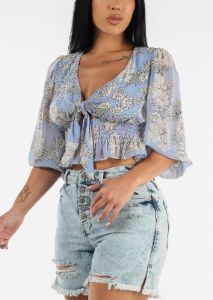 Front Knot Ruffle Hem Floral Crop Top Blue sold by Moda