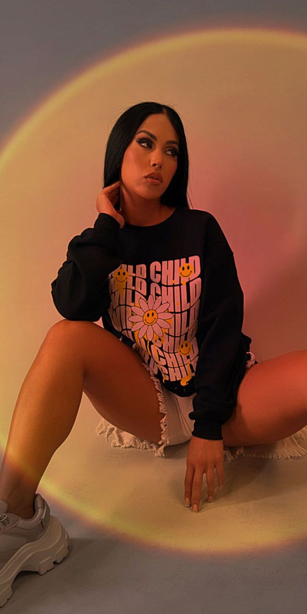 White Mid Thigh Distressed Denim Shorts with Black Vintage Graphic Sweatshirt sold by Moda