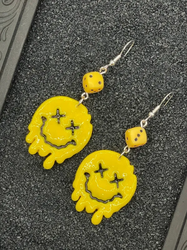 Drippy Smiley Face with Dice Earrings sold by Modcloth