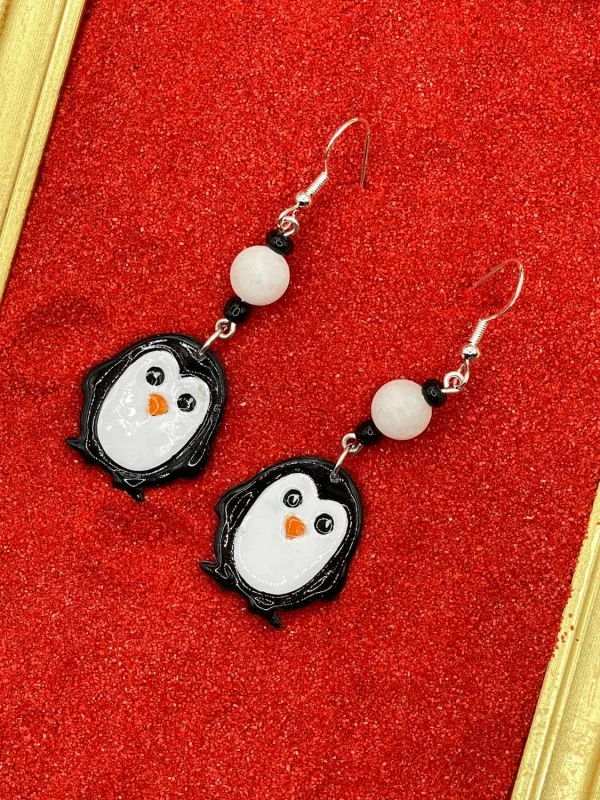 Cutie Little Penguin Earrings sold by Modcloth