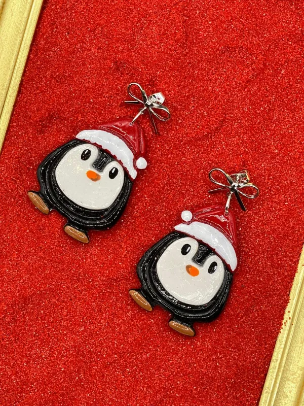 Santa Penguin Dangle Earrings sold by Modcloth