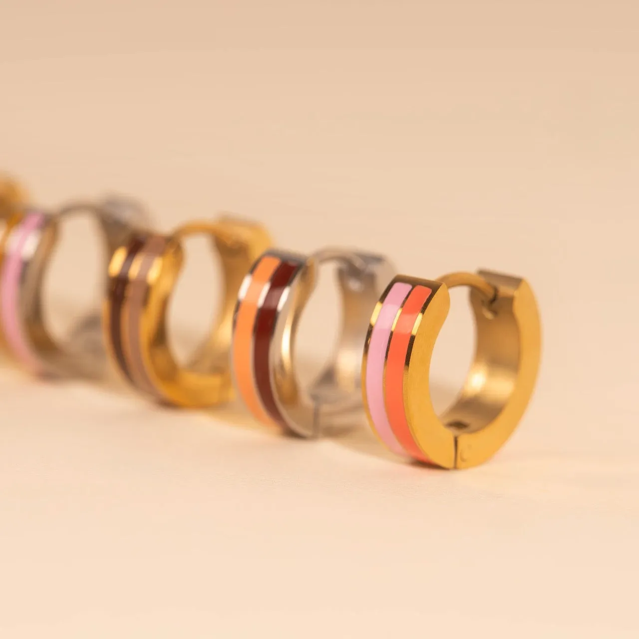 Striped Chunky Huggie Hoop Earrings sold by Modcloth