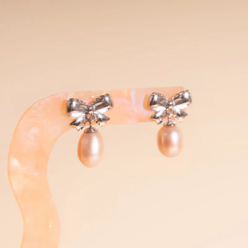 Bow Pearl Drop Stud Earrings sold by Modcloth