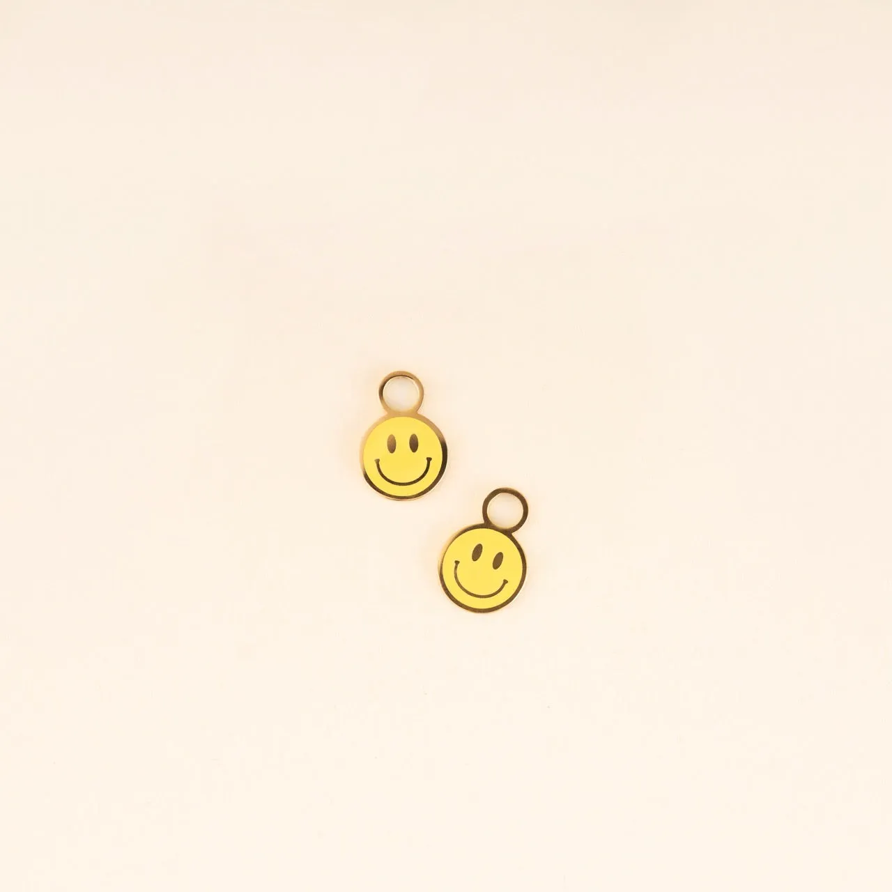 Smiley Huggie Hoop Charms sold by Modcloth