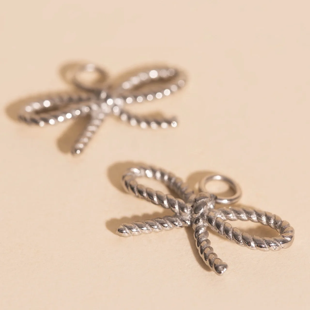 Rope Bow Huggie Hoop Charms sold by Modcloth