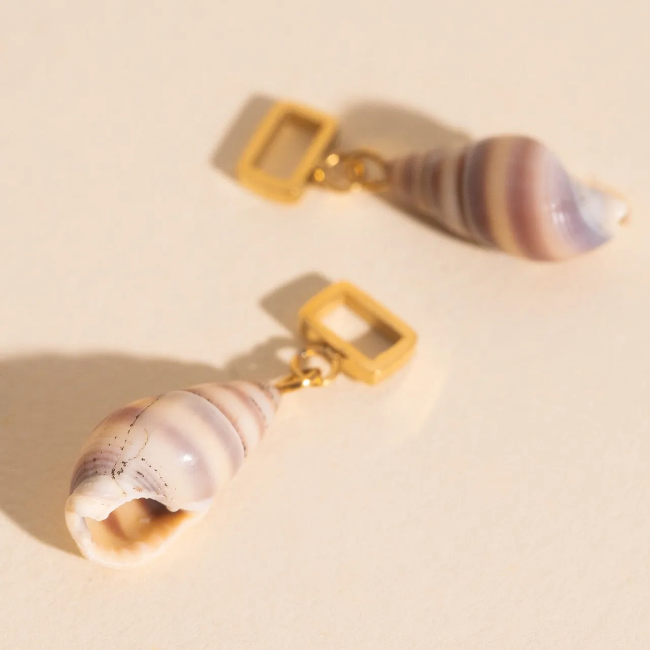 Spiral Shell Chunky Huggie Hoop Charms sold by Modcloth