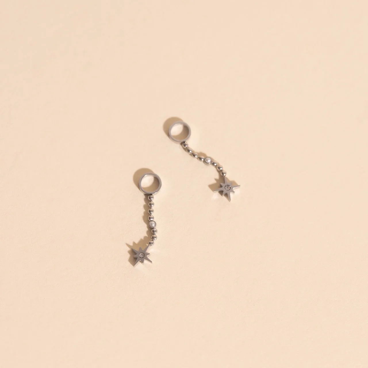 Dangle Starburst Huggie Hoop Charms sold by Modcloth