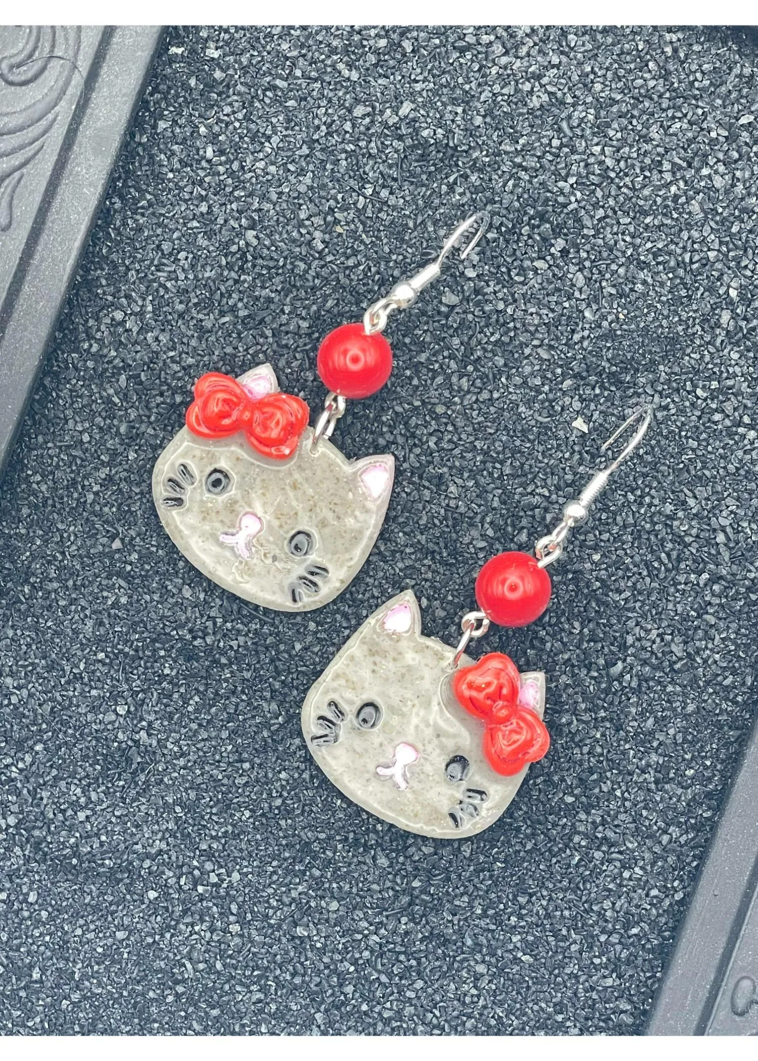 Kitty Cat with Red Bow Earrings sold by Modcloth