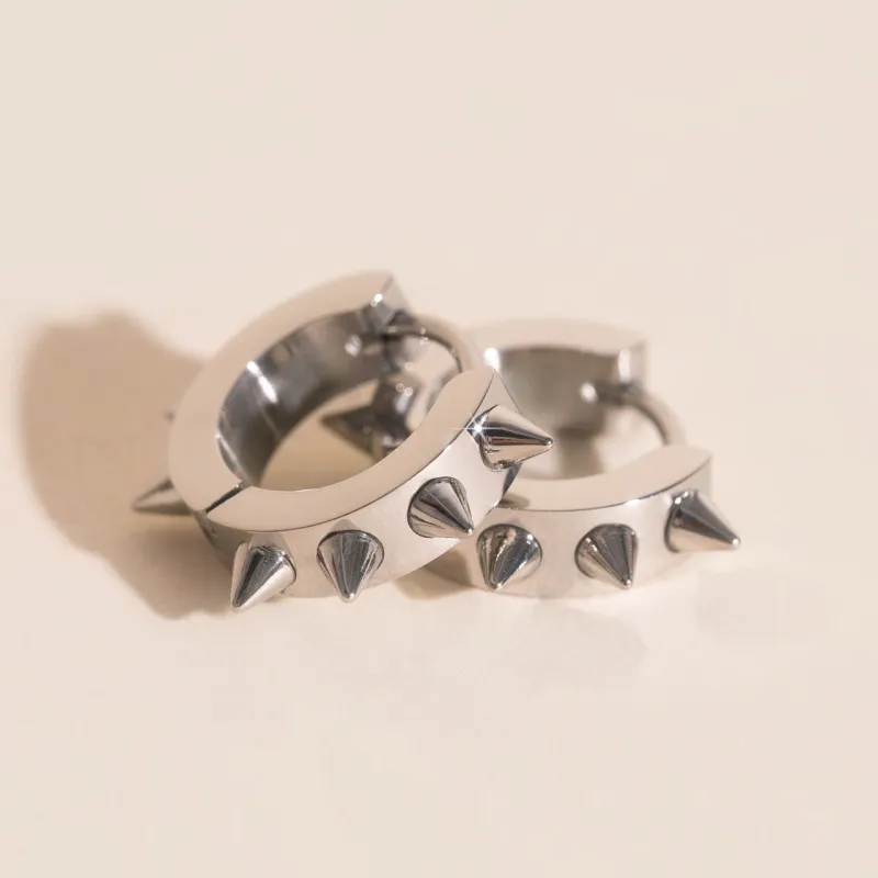 Spiked Chunky Huggie Hoop Earrings sold by Modcloth