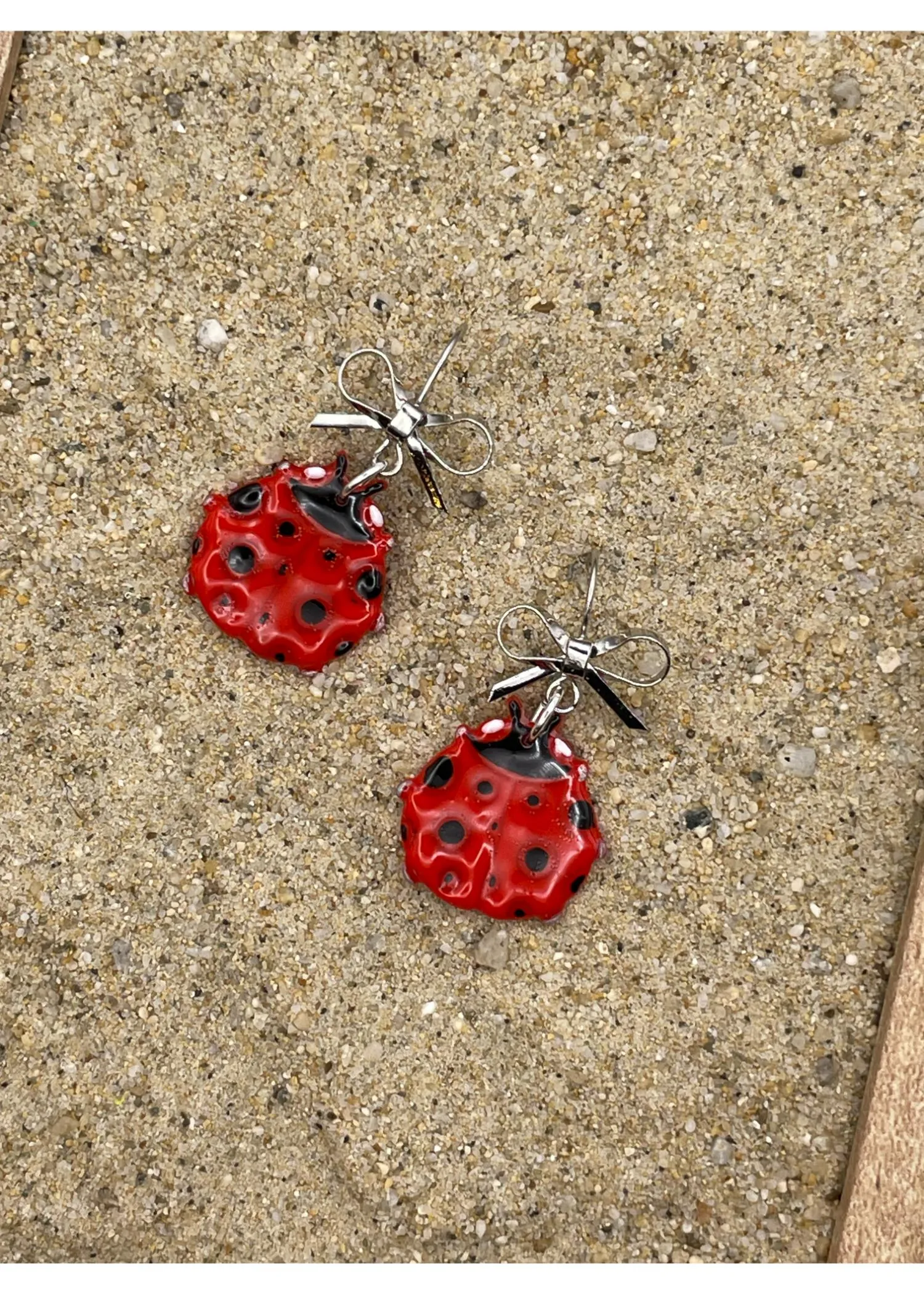 Lady Bug Dangle Earrings with Bow sold by Modcloth