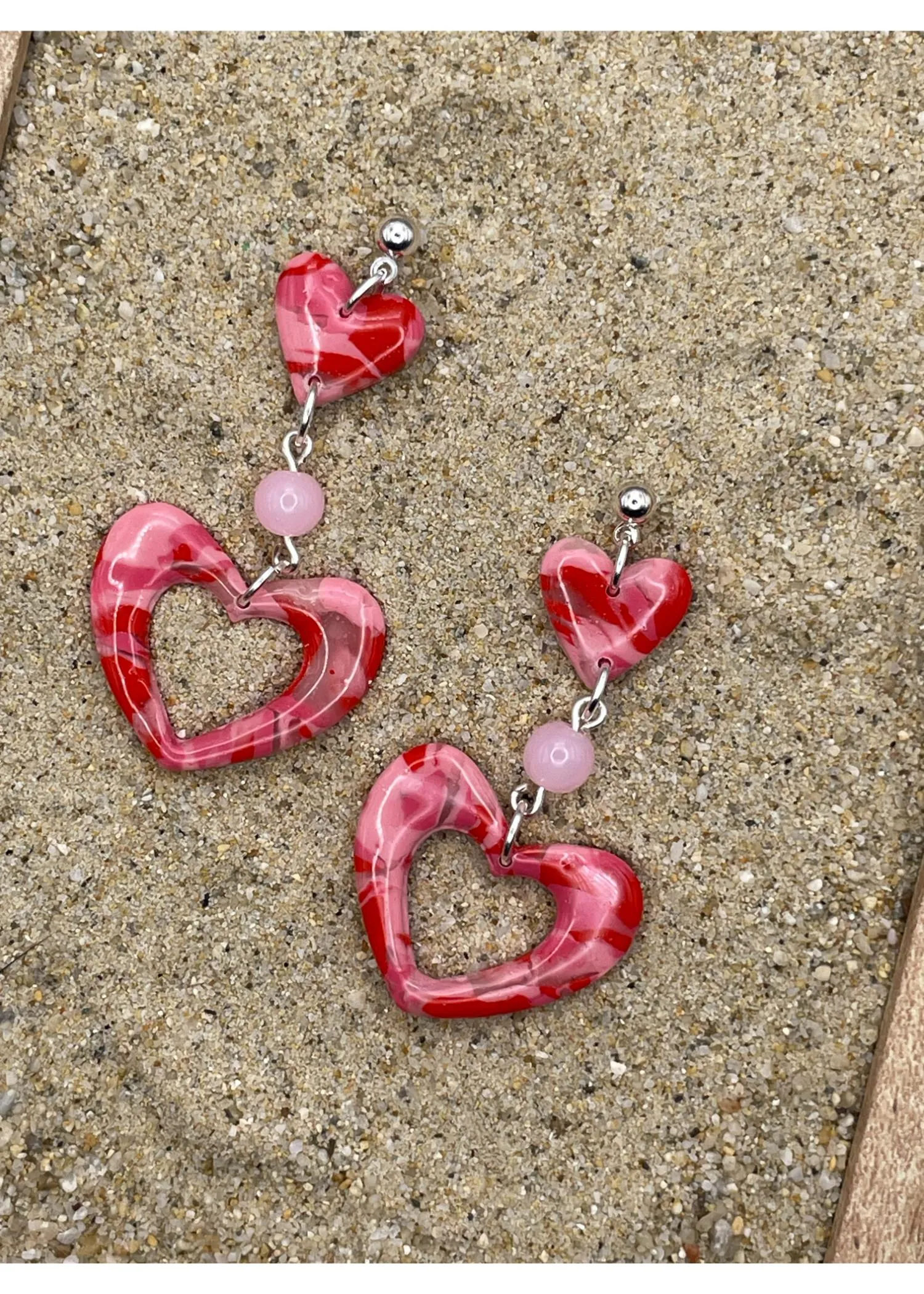 Double Heart Swirl Earrings with Pink Gemstone sold by Modcloth