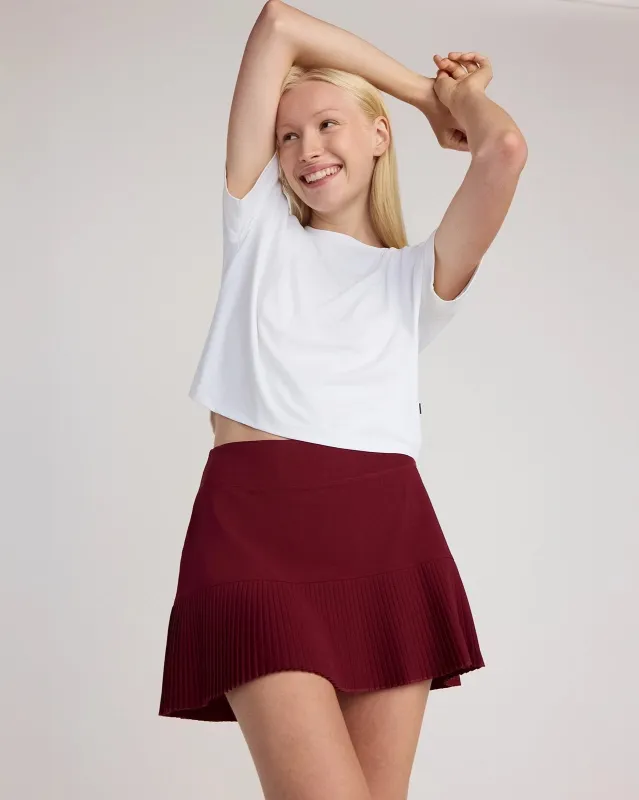The Pleated Built-In Liner GRS Certified Recycled Poly Skort - Cabernet sold by Mondetta