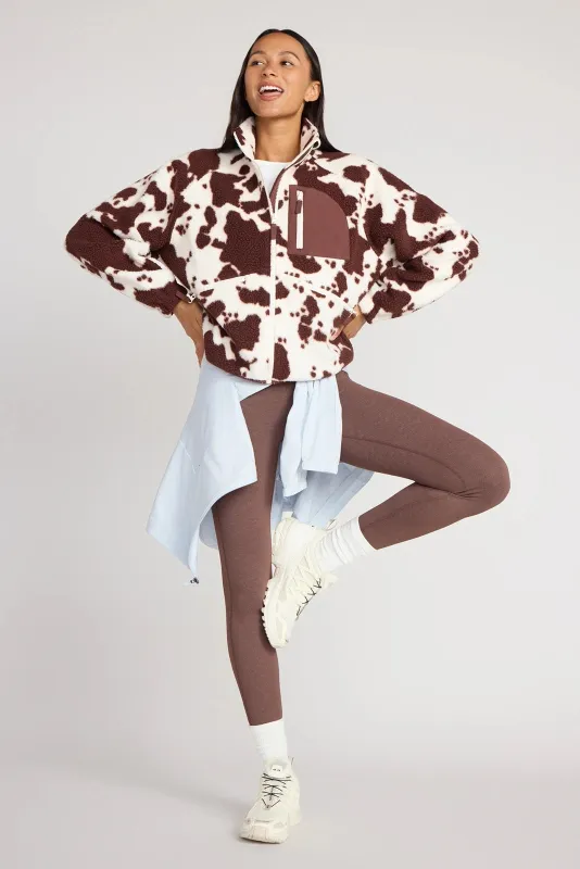 The Berber Soft Luxe GRS Certified Recycled Poly Zip Front Jacket - Cow Print sold by Mondetta