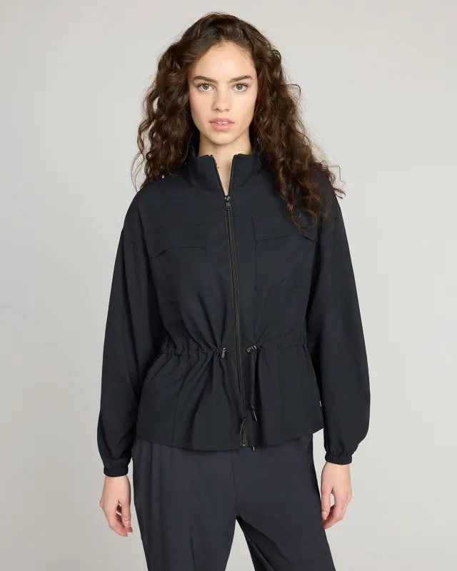 The Travel GRS Certified Recycled Poly Cinched Waist Jacket - Black sold by Mondetta