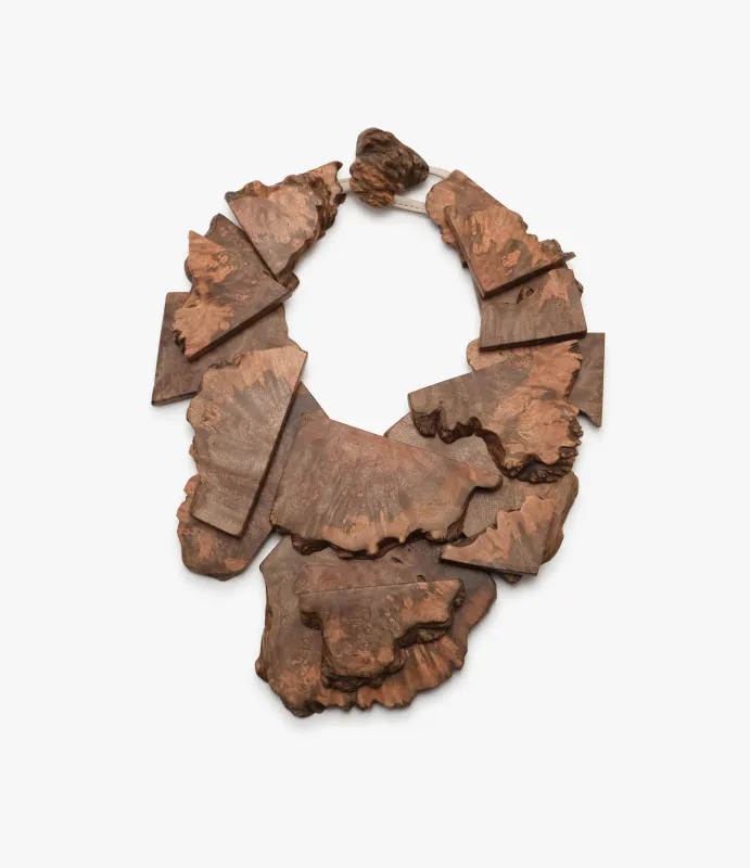 Necklace: bruyere wood, leather sold by Monies