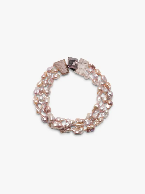 Necklace: ruthilated quartz, amethyst, baroque pearl sold by Monies