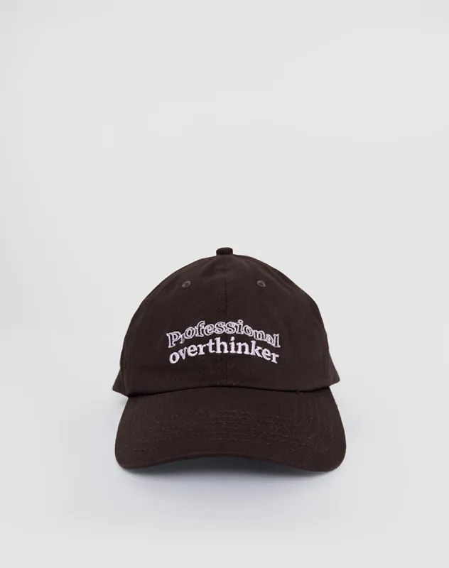 Cap in Bitter Chocolate with Professional Overthinker Slogan sold by Motel Rocks