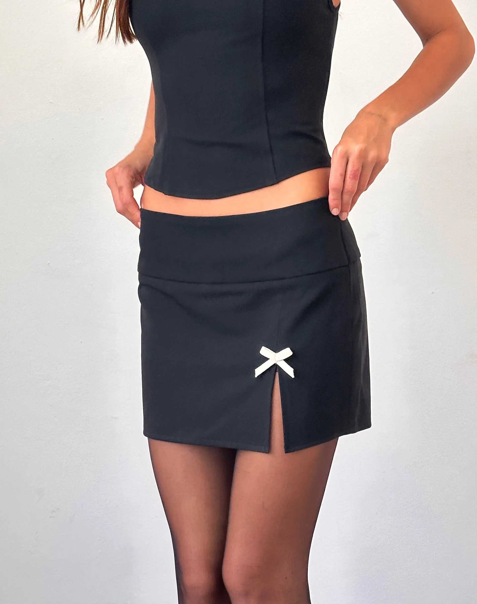Yanti Mini Skirt in Black with Ivory Bows sold by Motel Rocks