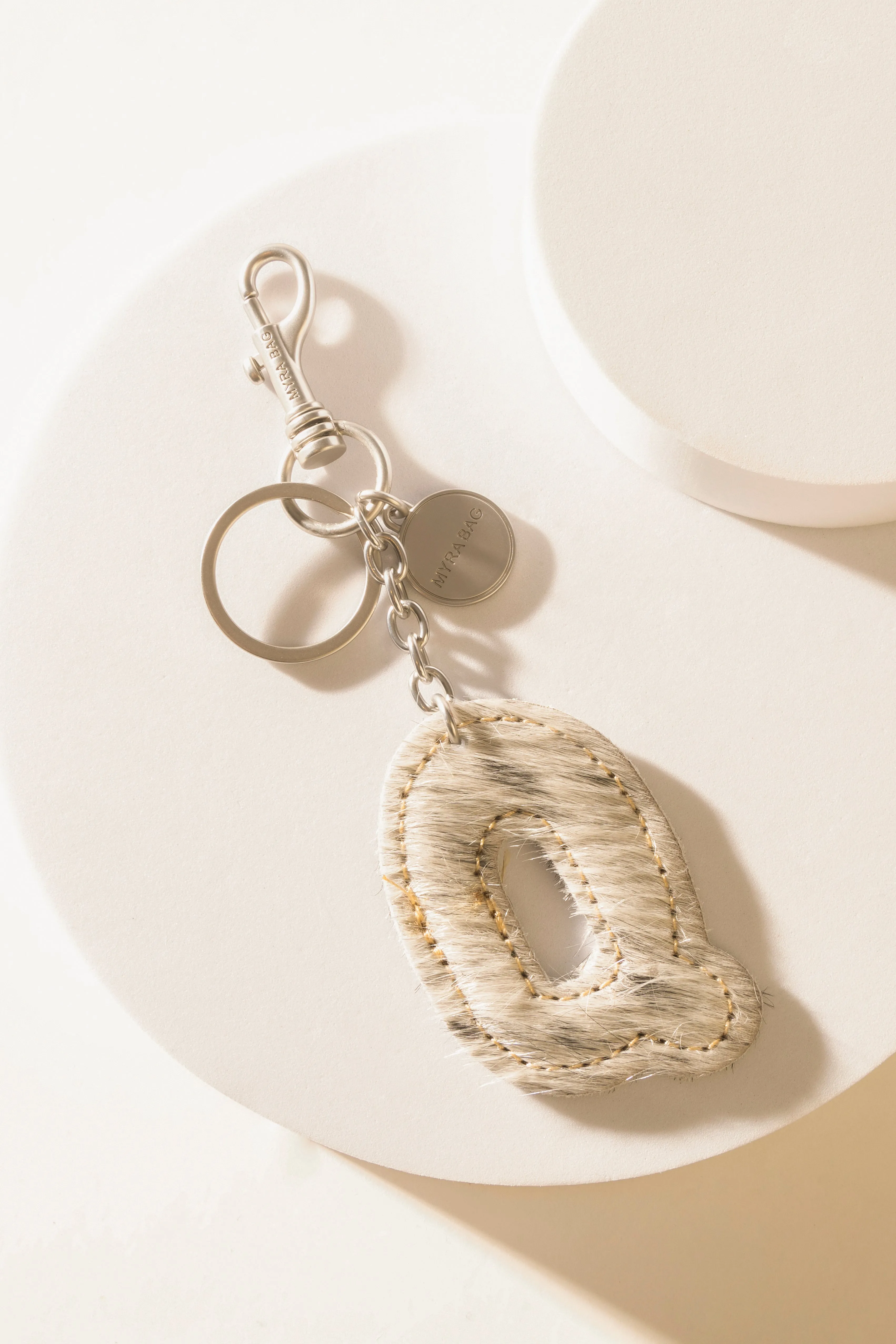 Alpha 'Q' Hairon Bag Charm in Vanilla Dust sold by Myra Bag