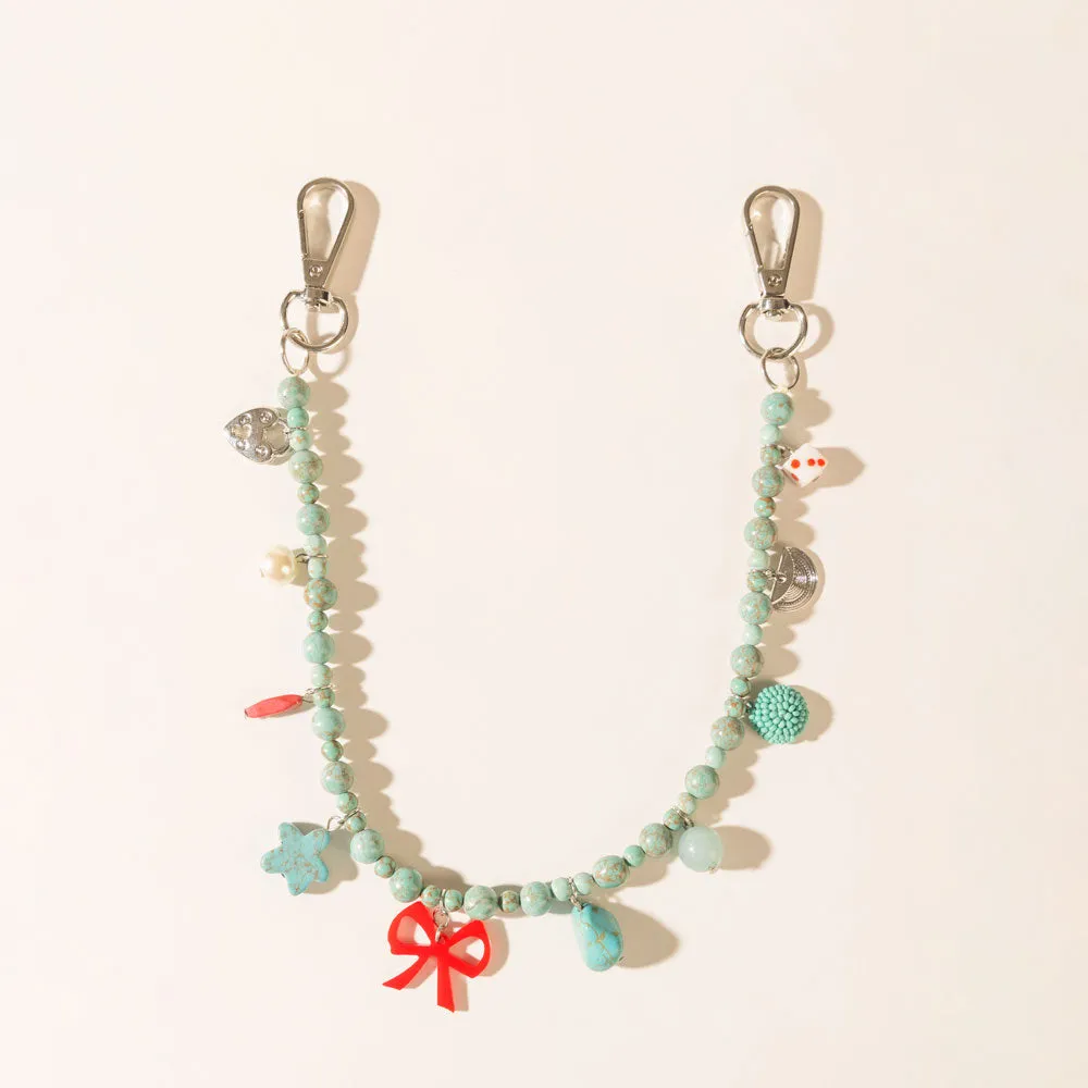 Nina’s Lucky Bag Charm in Ocean Blue sold by Myra Bag