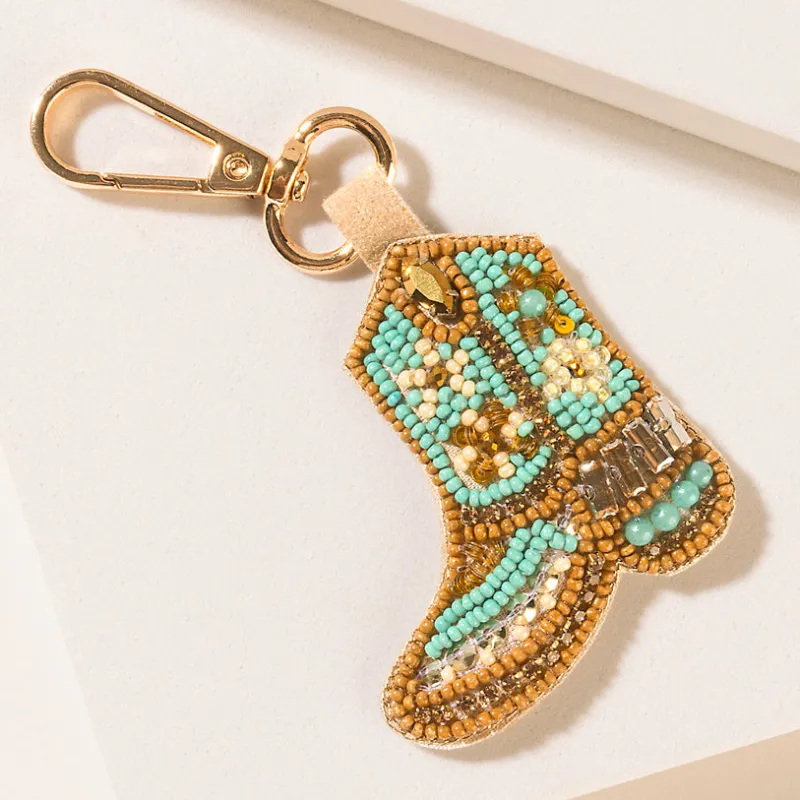 Saddle Song Boot Keychain in Desert Pearl sold by Myra Bag