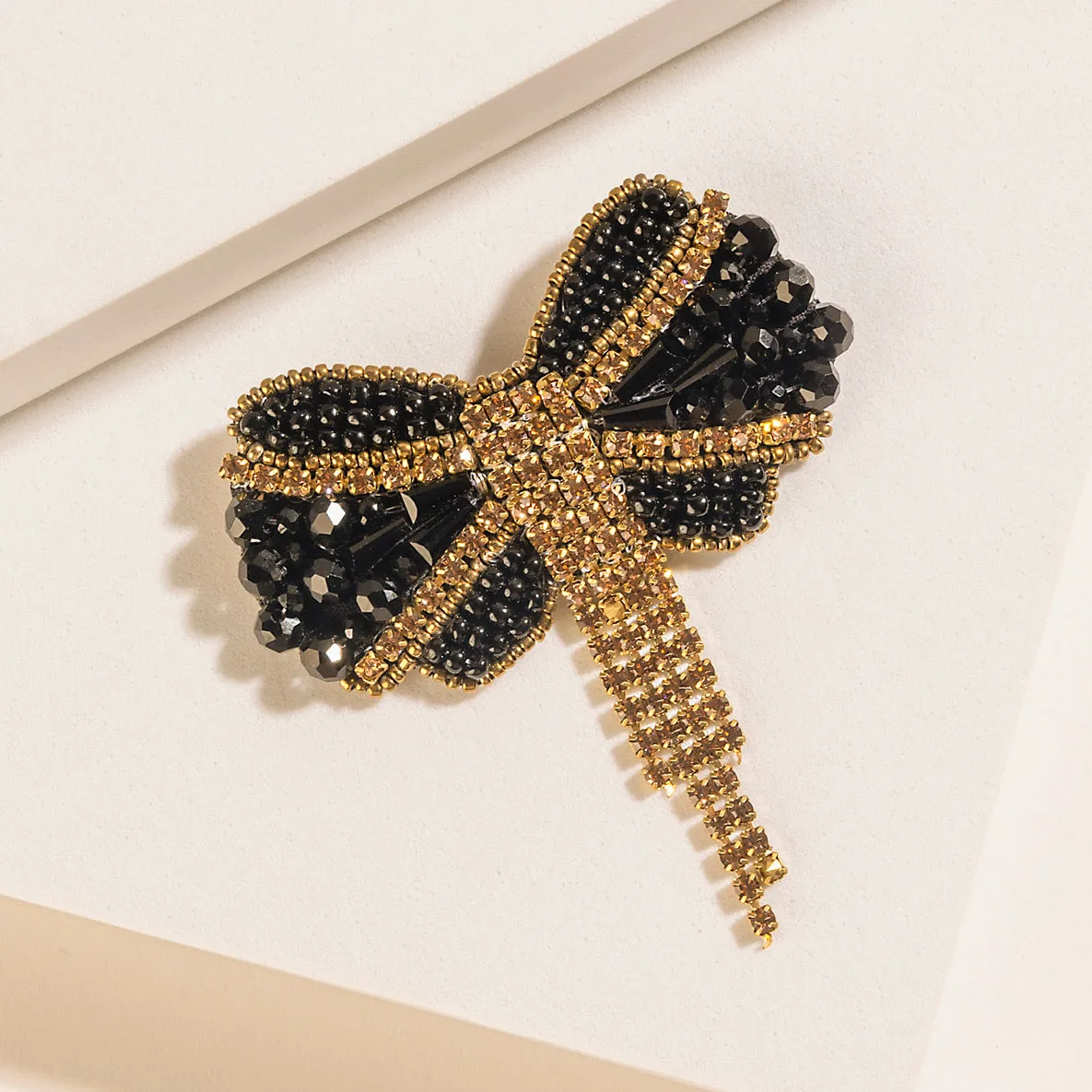 Evening Grace Bow Brooch in Gilded Gold sold by Myra Bag