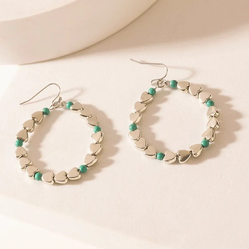 Trail of Hearts Hoop Earrings in Arctic Silver sold by Myra Bag