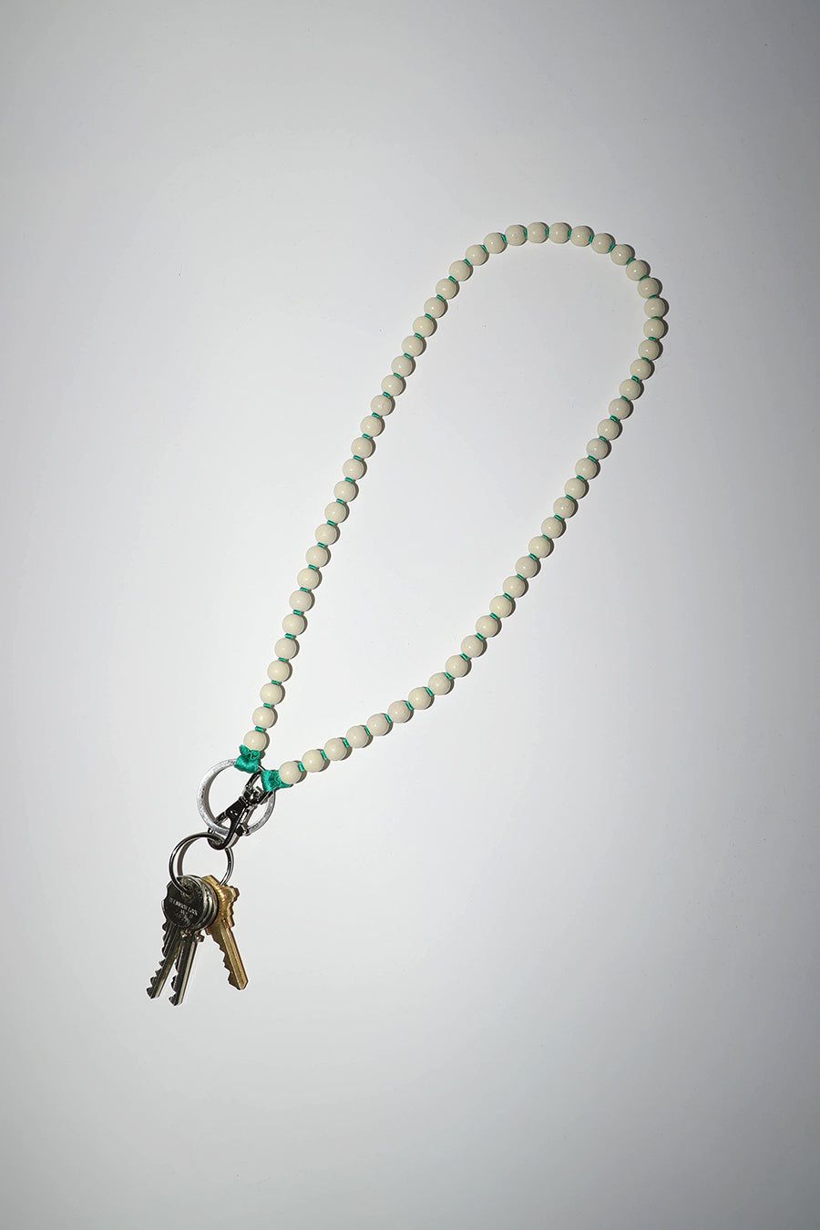 Ina Seifart Perlen Long Keyholder in Opal with Green Thread sold by No. 6