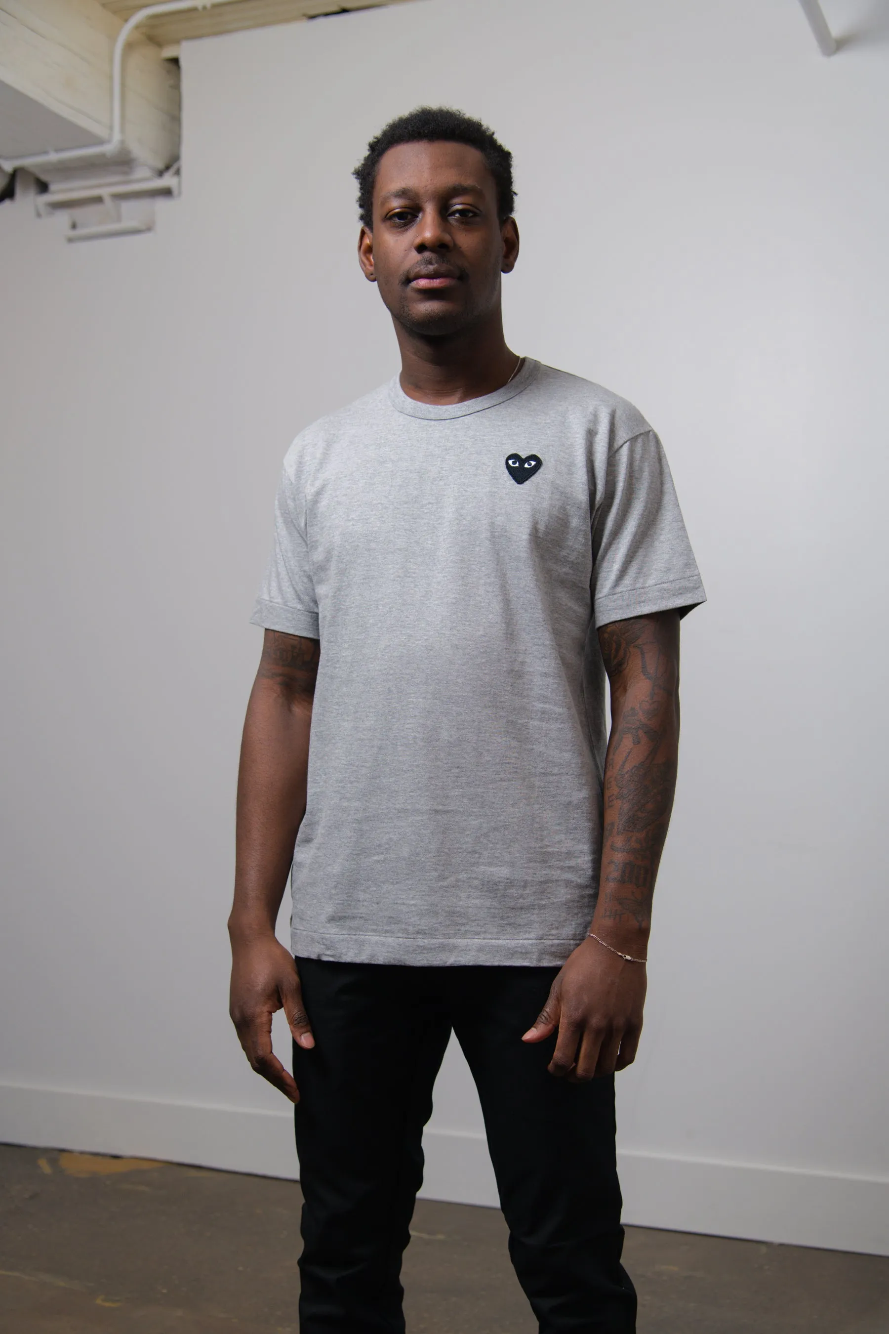 Emblem Tee Grey/Black T076 sold by Nomad