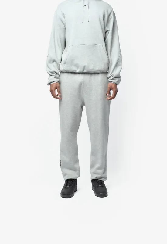 NOCTA CS Fleece Tracksuit Bottoms Dark Grey Heather/Matte Silver/Black HM5764-063 sold by Nomad