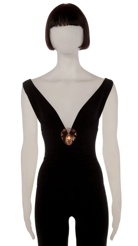 BRASS FACE ON LUCITE BROOCH sold by Norma Kamali