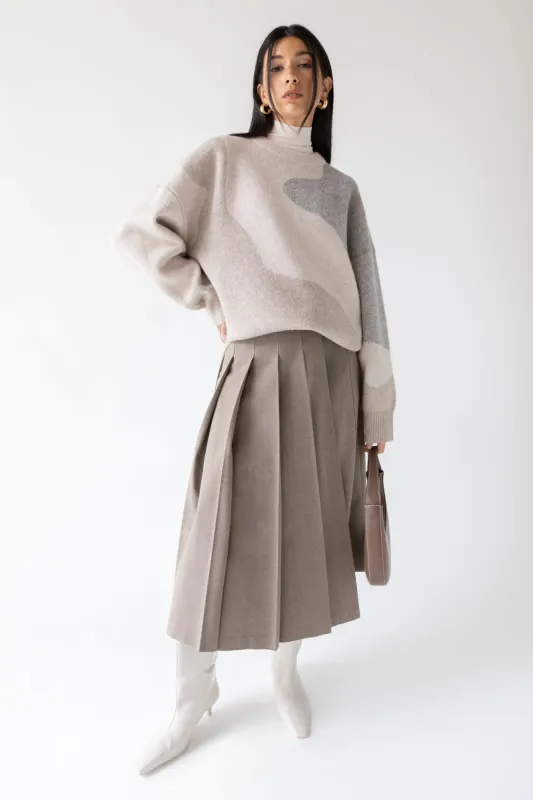 MIDI PLEATED ASYMMETRICAL SKIRT sold by OAK AND FORT