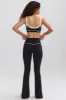 Petite Soft Active Contrast-Trim Flared Trousers in Black sold by Oh Polly