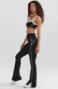 Petite Soft Active Contrast-Trim Flared Trousers in Black sold by Oh Polly