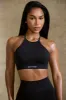 High Neck Open Back Define Luxe Sports Bra in Black sold by Oh Polly