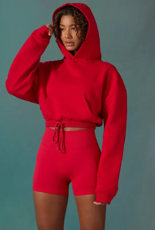 Cropped Drawstring Hooded Sweatshirt in Tango Red sold by Oh Polly